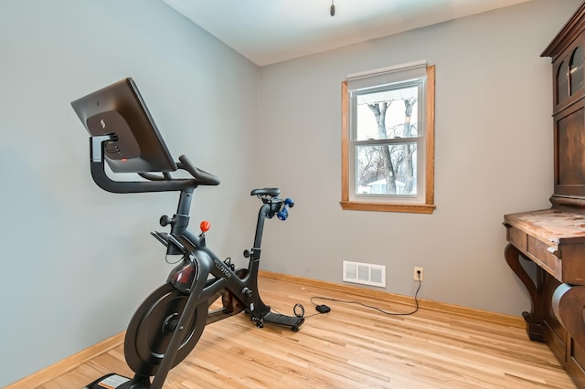 exercise room featuring light wood-type flooring