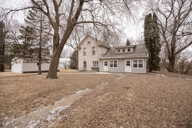 view of front facade featuring a garage and an outdoor structure