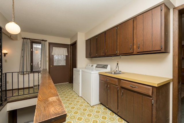 laundry room featuring sink, cabinets, and washer and dryer