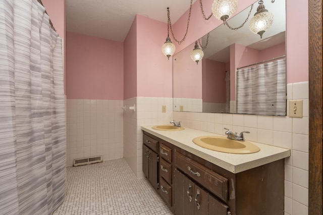 bathroom featuring vanity, tile walls, and tile patterned floors