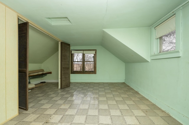 additional living space featuring lofted ceiling