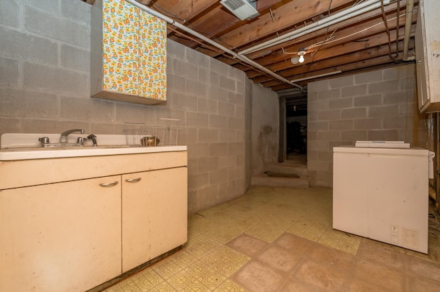 basement with sink and fridge