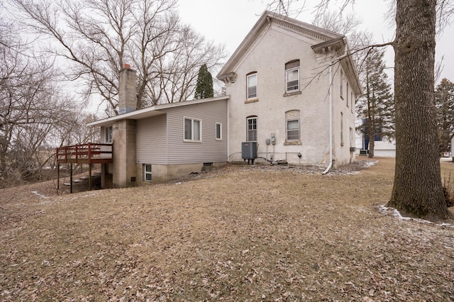 back of house with a wooden deck and central air condition unit