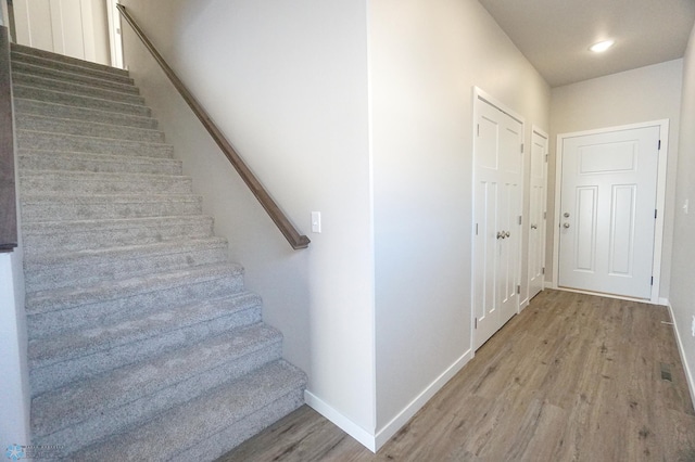 staircase featuring hardwood / wood-style floors