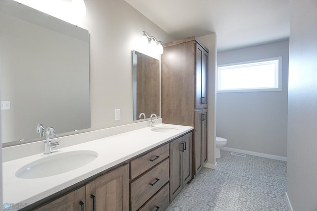 6020 80th Ave S, Fargo, ND 58047 - full bathroom with toilet, double vanity, baseboards, and tile patterned floors