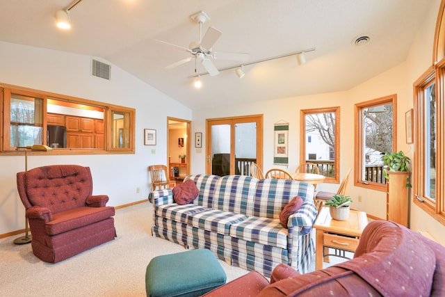 living area with vaulted ceiling, carpet flooring, visible vents, and a ceiling fan