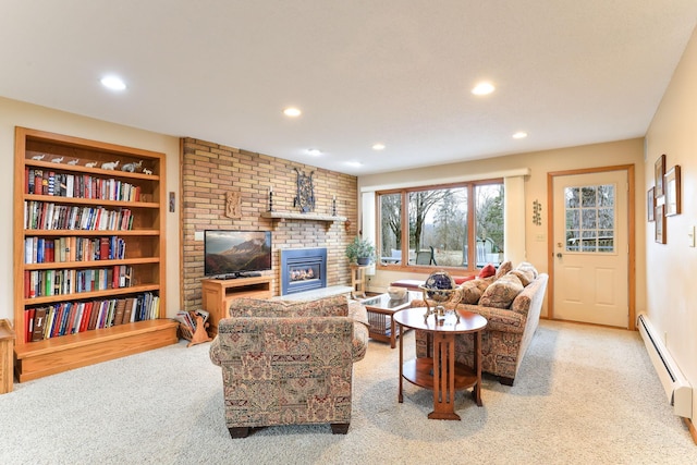 living area with carpet floors, a baseboard radiator, a fireplace, and recessed lighting