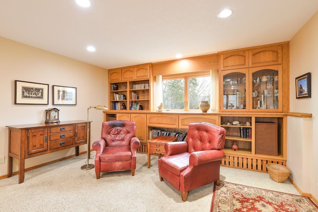 living area featuring recessed lighting, light carpet, and baseboards