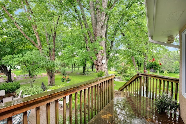 wooden terrace with a lawn