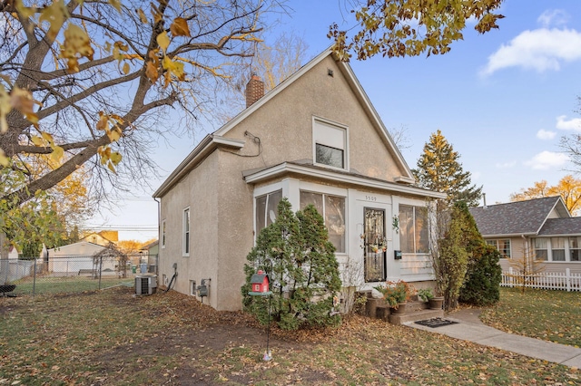 view of front of home with a sunroom and cooling unit