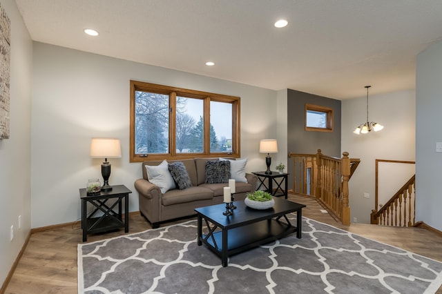 living room with hardwood / wood-style flooring and an inviting chandelier