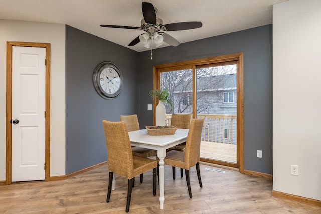 dining space featuring ceiling fan and light hardwood / wood-style floors