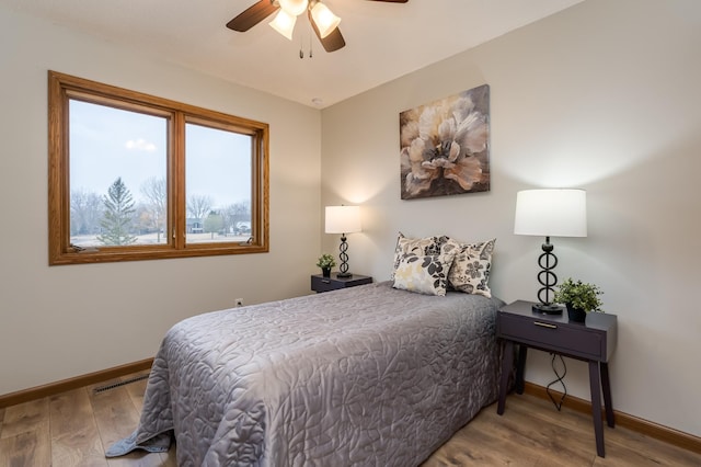 bedroom featuring hardwood / wood-style floors and ceiling fan