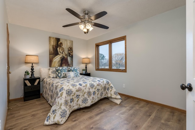 bedroom featuring ceiling fan and wood-type flooring