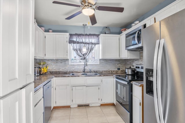 kitchen featuring white cabinetry, stainless steel appliances, and a sink