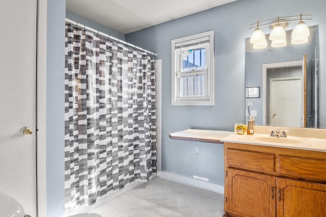 full bathroom with vanity, a shower with curtain, baseboards, and marble finish floor