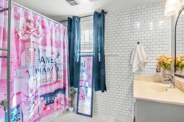 full bath with visible vents, vanity, and tile patterned flooring