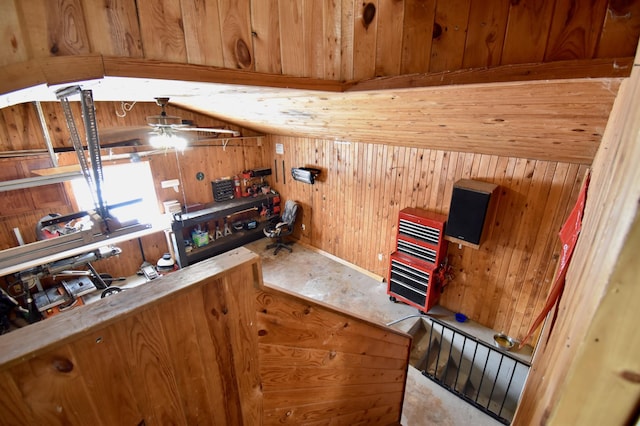 kitchen featuring ceiling fan, wooden walls, wood ceiling, vaulted ceiling, and brown cabinets