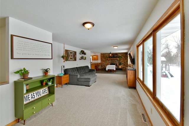 carpeted living area featuring visible vents and a fireplace