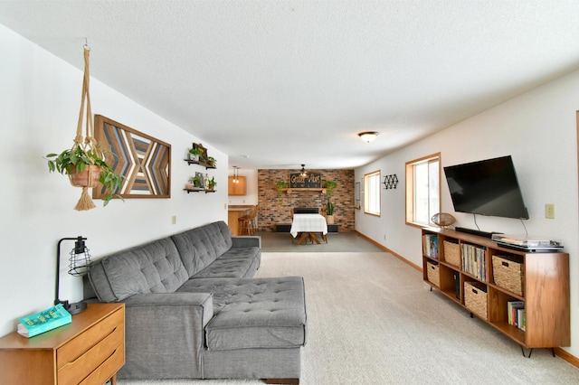 living room featuring light carpet, a textured ceiling, and baseboards