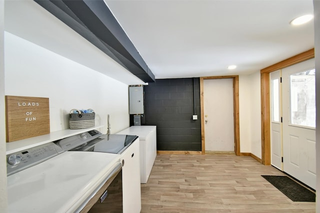 laundry room with light wood-style floors, laundry area, water heater, and washing machine and clothes dryer