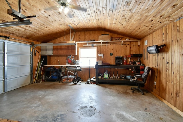 garage featuring wood walls, a workshop area, and wood ceiling