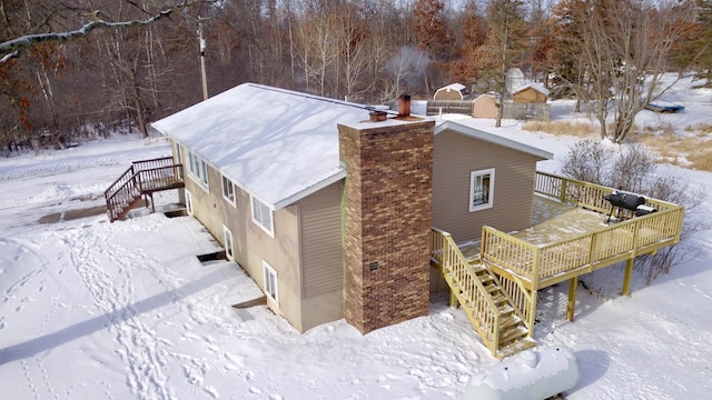 exterior space featuring a chimney, stairway, and a deck