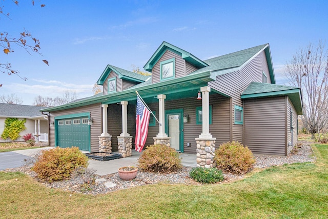 view of front facade with a garage, a front yard, and covered porch