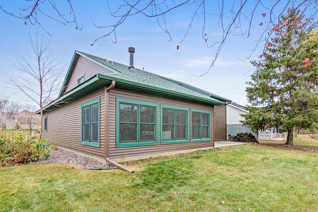 view of side of home featuring a lawn