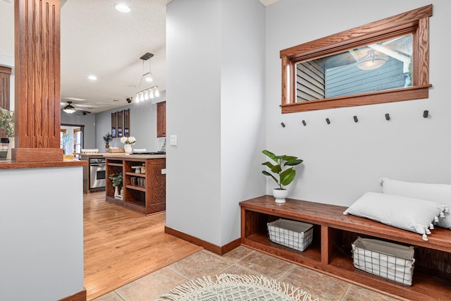 mudroom featuring light tile patterned floors and ceiling fan