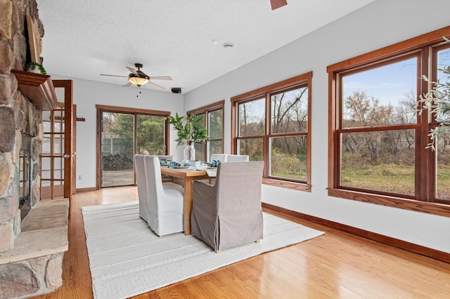 unfurnished sunroom featuring ceiling fan