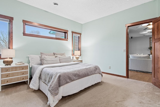 bedroom with a textured ceiling and carpet