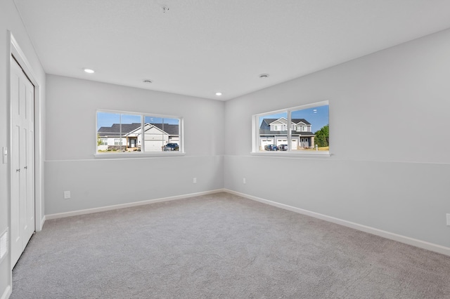 unfurnished bedroom featuring recessed lighting, carpet, and baseboards