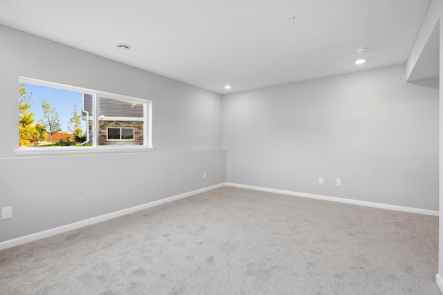 spare room with recessed lighting, carpet, and baseboards