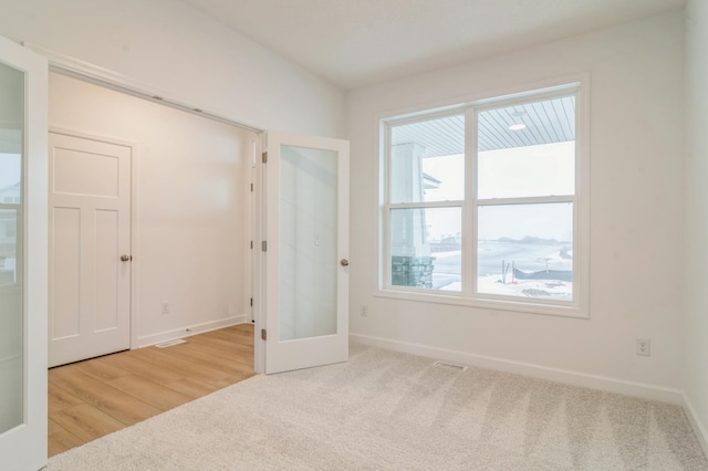 unfurnished room featuring light colored carpet