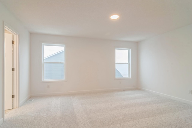 spare room with light colored carpet