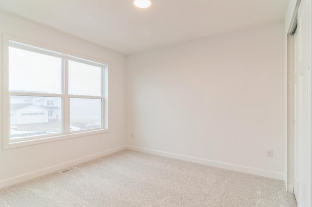 unfurnished room with light colored carpet