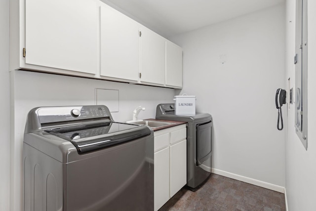 washroom with separate washer and dryer, sink, and cabinets