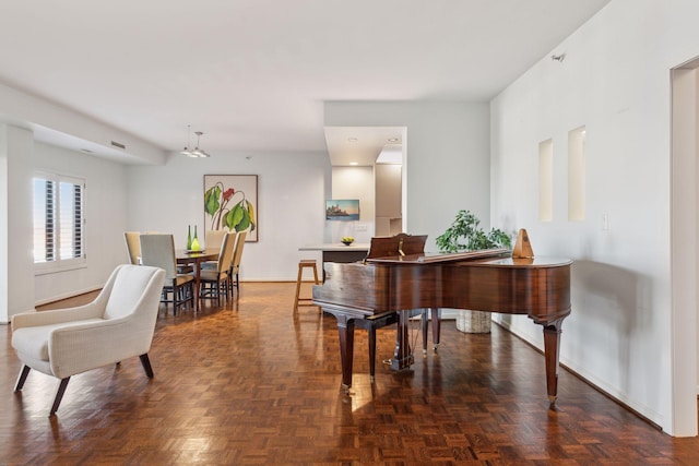 miscellaneous room featuring dark parquet flooring