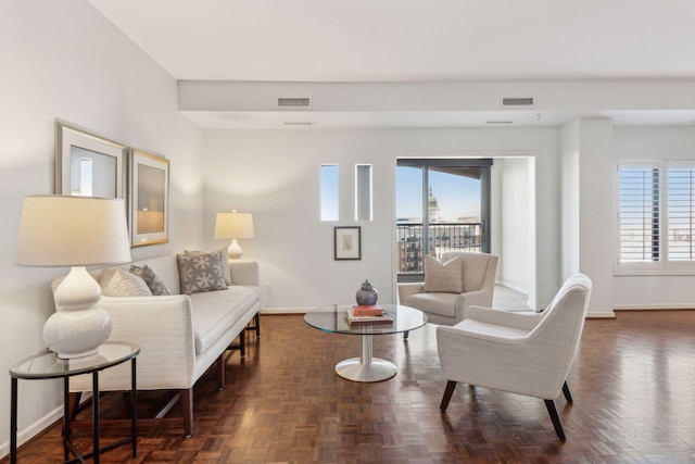 living room featuring dark parquet floors