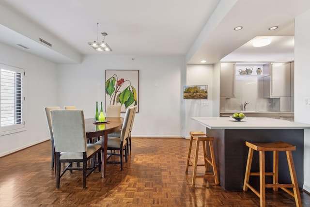 dining room with sink and dark parquet floors