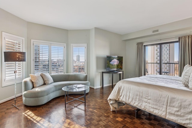 bedroom with multiple windows and dark parquet floors