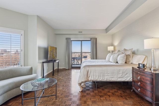 bedroom featuring access to exterior and dark parquet floors