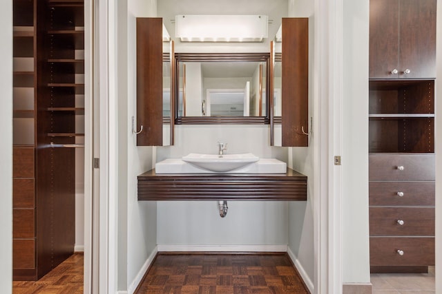 bathroom with parquet floors and sink