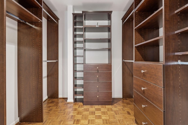 spacious closet with light parquet flooring