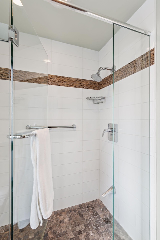 bathroom with a shower with shower door