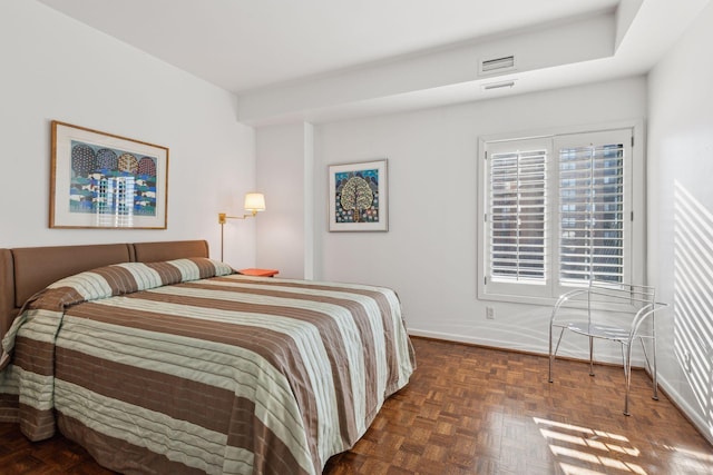 bedroom with dark parquet floors