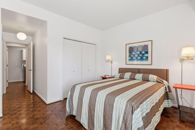 bedroom with a closet and dark parquet floors