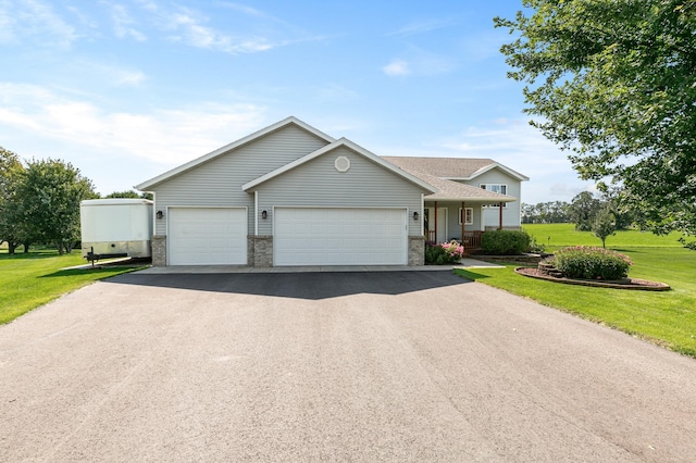 single story home featuring covered porch, driveway, a front lawn, and an attached garage