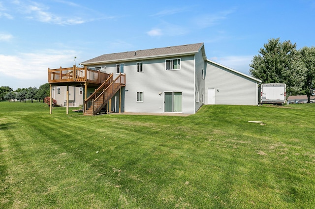 rear view of house featuring stairs, a deck, and a yard